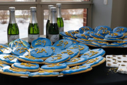 bottles in background and blue cookies with yellow 29 on them in foreground