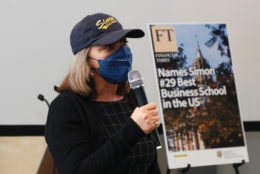 woman in cap, mask and mic in hand