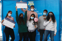 group of students posing at photo booth area