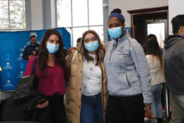 three woman posing for photo all wearing a mask