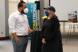 man and woman speaking to each other both with masks