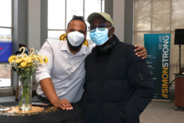 two men posing together both wearing masks