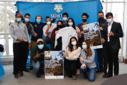 large group of students all in masks posing in photo booth