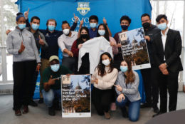 large group of students all in masks posing in photo booth