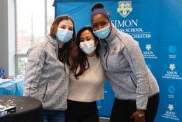three female students posing wearing masks