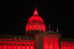 SF War Memorial building tower lighted up red at night