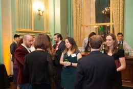 group of people in ballroom standing around chatting during event