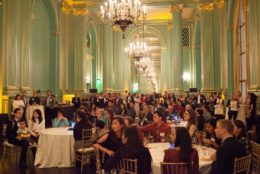 large ballroom full of people seated at tables
