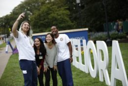 four people taking selfie in front of meliora letters at SON