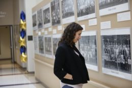woman looking at old class photos at SMD