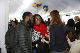 three people in circle talking in tent