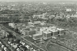 1974 black/white aerial image of URMC campus in foreground river campus in background