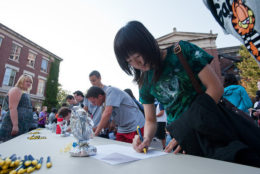 woman signing in at desk during convocation