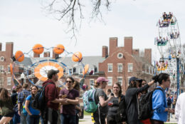 quad full of students and carnival rides during dandelion day