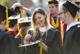 Sarah Hackley fixes her cap while getting lined up for University of Rochester commencement