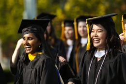 Graduates walk towards the quad at the University of Rochester commencement