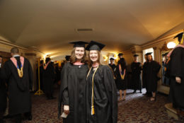 Kaithe Wright Kaufman and Kyrsten Chambers pose for a quick picture before they get in line to walk for graduation