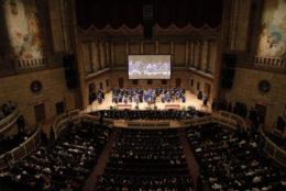 view of the stage at eastman theatre with a full crowd and stage