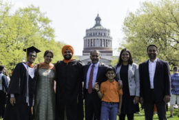 family lined up posing for photo with graduate
