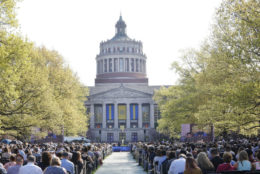 crowd outdoors with rush rhees library in the background