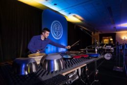 man on stage playing percussion