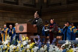 man in regalia speaking at podium during inauguration