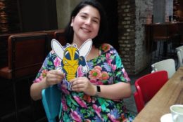 woman posing for photo holding a rocky cutout