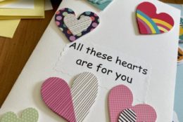 homemade greeting card that says all these hearts are for you with heart cutouts
