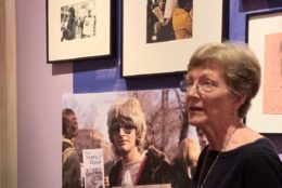 woman giving talk in front of art exhibit