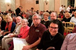 group of people seated in rows of chairs