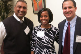 woman and two men smiling for photo