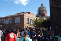 large crowd outdoors with rush rhees tower in background