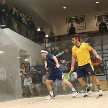 two men playing basketball in the gym