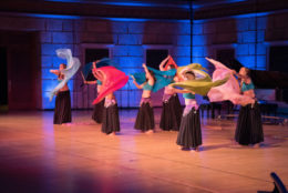 group of belly dancers performing on stage