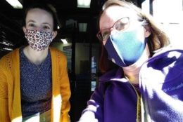 two women in masks taking a selfie
