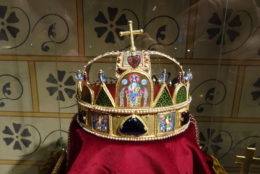 crown on display over red clothe