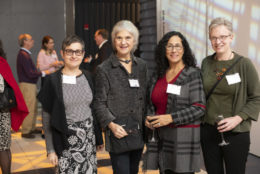 four women smiling for a photo