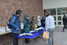 student picking up her i heart UR tshirt from a table