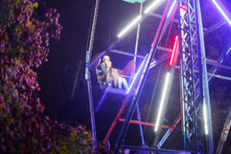 couple on ferris wheel with lights at night