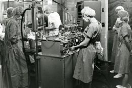1962 black/white photo of hospital workers using the heart-lung machine