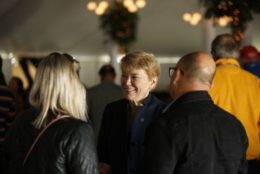 president mangelsdorf speaking to a couple in tent