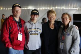 president mangelsdorf posing for photo with parents and daughter
