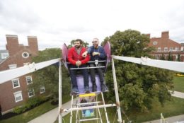 two men in ferris wheel above quad