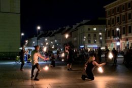 outdoor performers with fire sticks at night