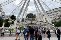 group posing in front of ferris wheel in budapest
