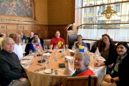 group posing for photo at dinner table