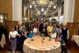 group of UR alumni posing in front of a dinner table