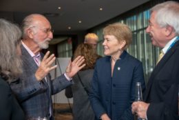 President Mangelsdorf speaking to two men and a women