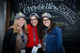 three women in R caps posing for photo