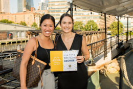 two women smiling for photo on a boat